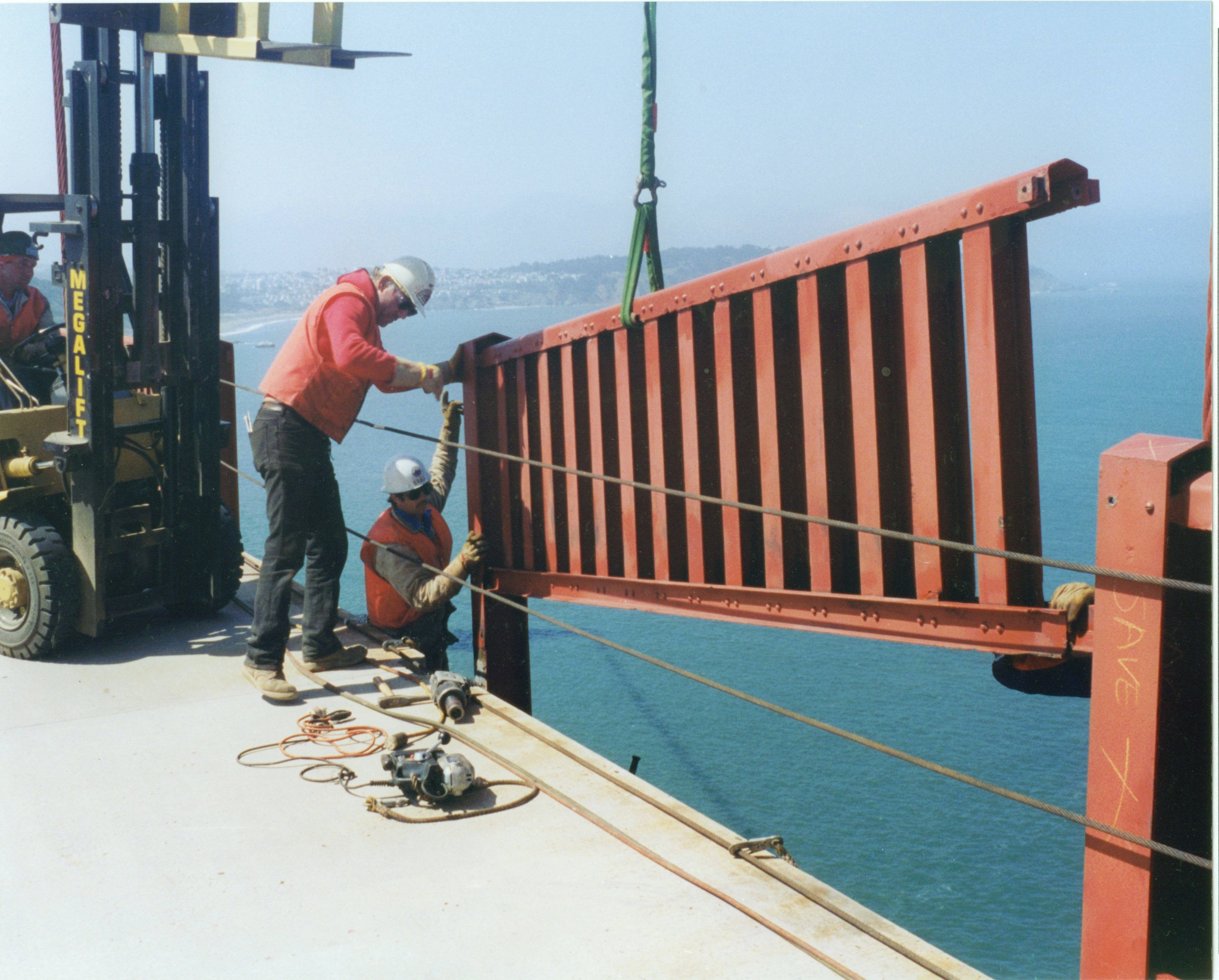 Workers removing a section of the Golden Gate Bridge pedestrian handrail in 1993